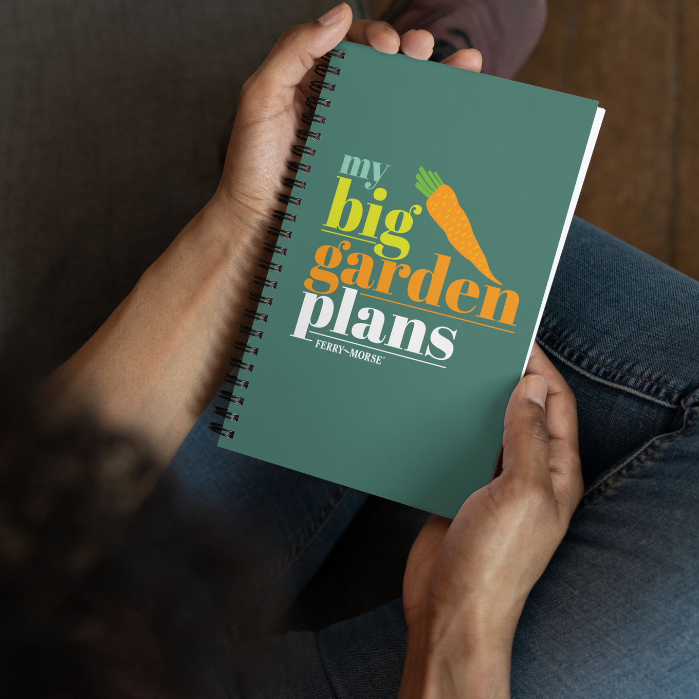 A green spiral-bound notebook with the title 'my big garden plans' printed on the cover, alongside an illustration of a carrot.