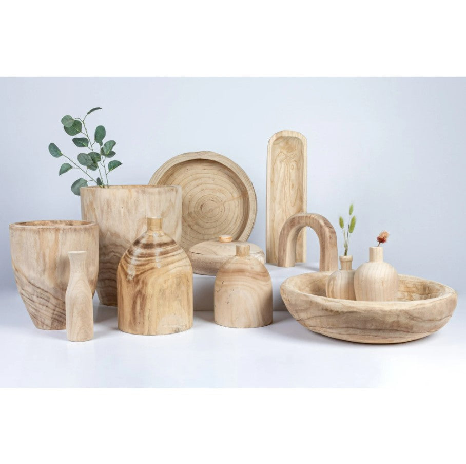 Set of wooden decorative items including bowls, vases, and a plant on a light background
