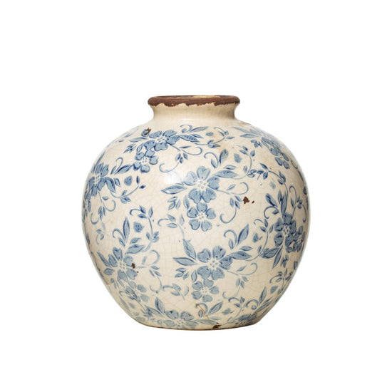 A round terracotta planter vase with a blue transferware pattern featuring floral motifs and geometric shapes.