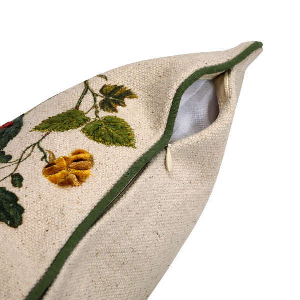 A rectangular cotton lumbar pillow with an embroidered butterfly and flower design on a beige mud cloth background, featuring green piping around the edges.