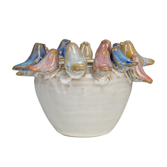 Decorative ceramic bowl with fish-shaped handles on a white background