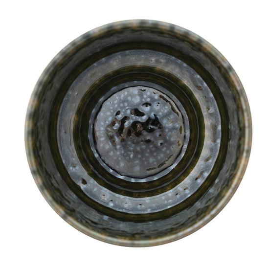 Stoneware planter with concentric circular patterns on a white background