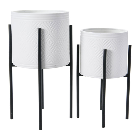 Two white textured planters with black stands on a white background