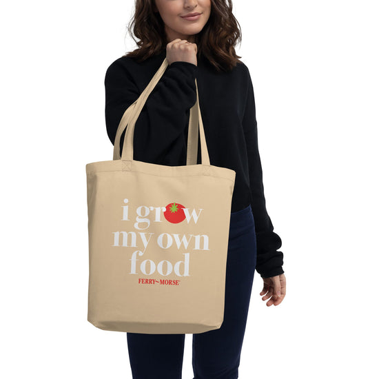 A beige tote bag with the text 'I GROW MY OWN FOOD' printed in white on the front