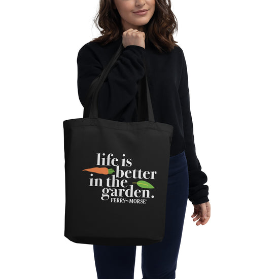 Black tote bag with the text 'life is better in the garden' printed on the front.