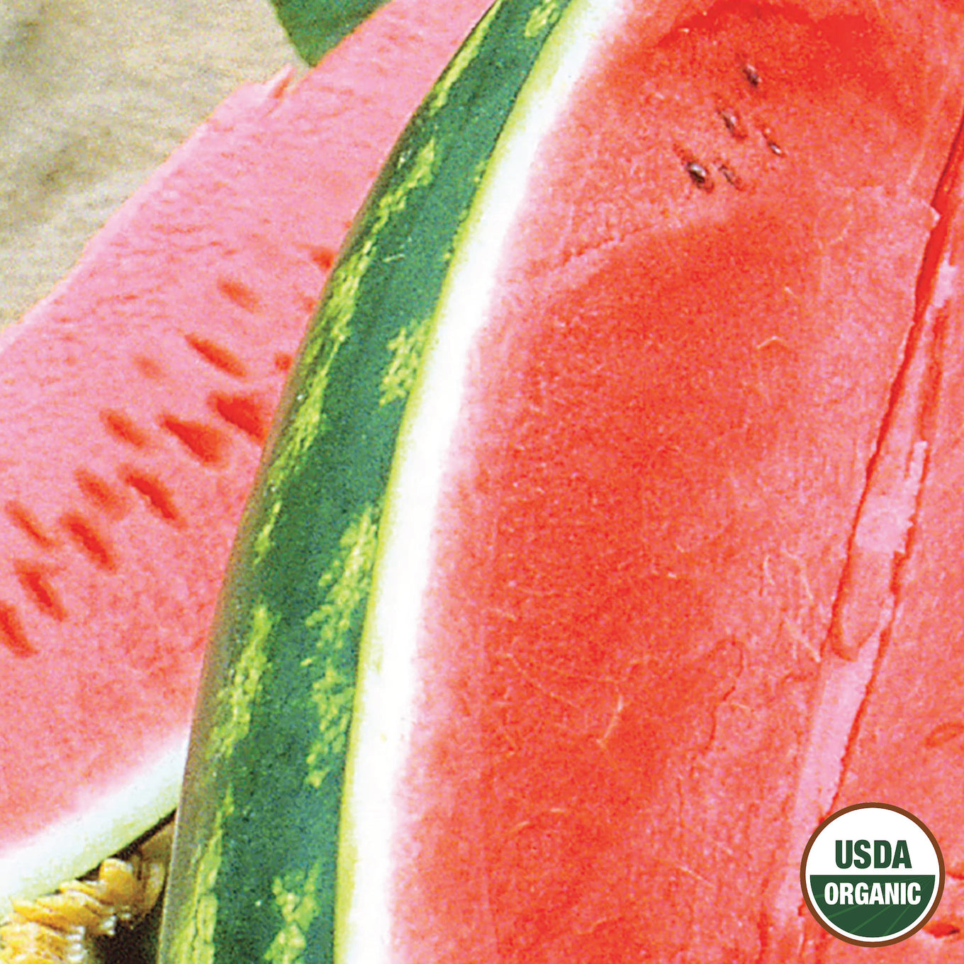 A close-up of a watermelon with a slice cut out, showing the red flesh and green skin with stripes.