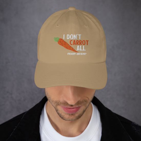 A khaki 'Dad hat' with the text 'I DON'T CARROT ALL' printed on the front, featuring a carrot image.