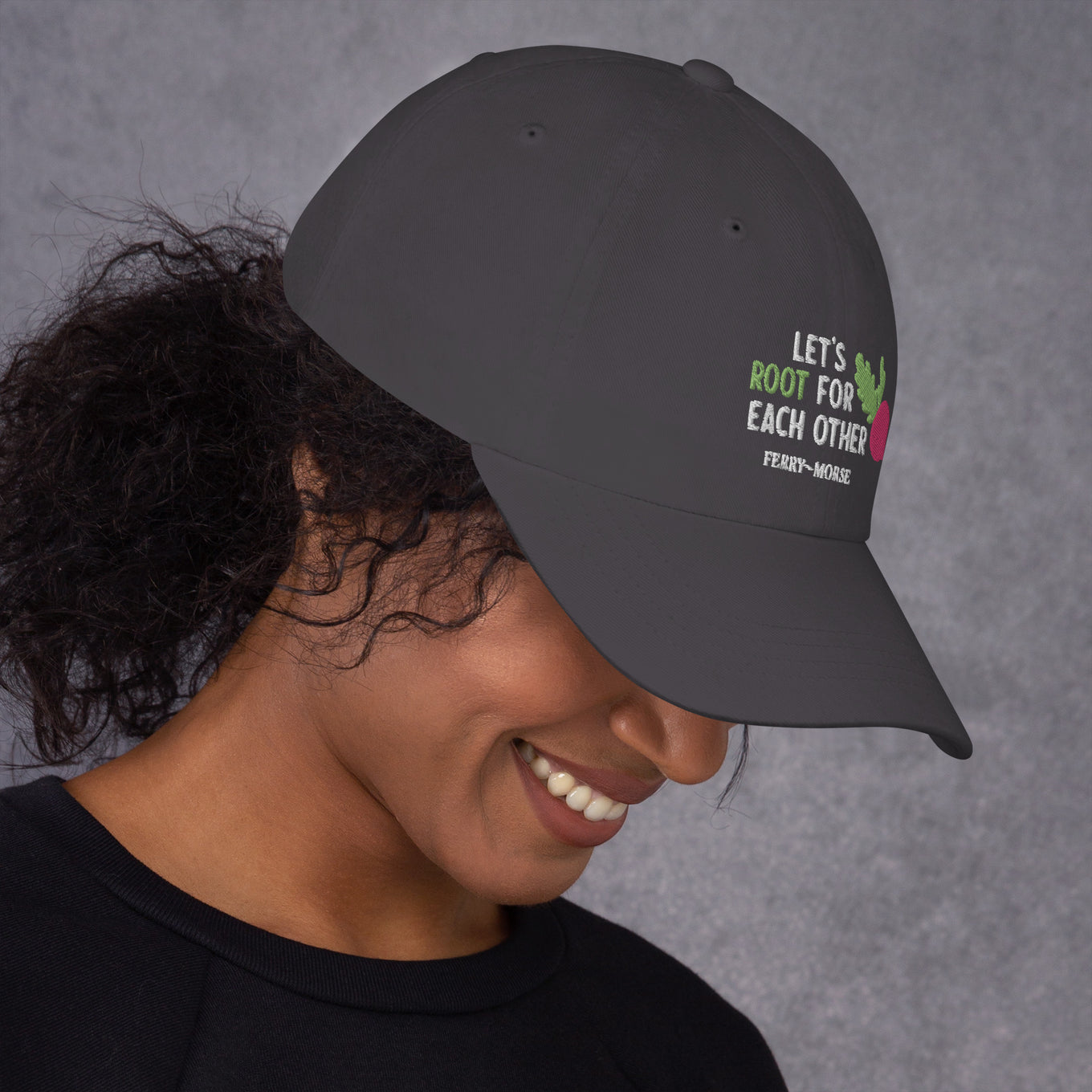 A grey hat with the text 'LET'S ROOT FOR EACH OTHER' and a graphic of a root vegetable on it on female model