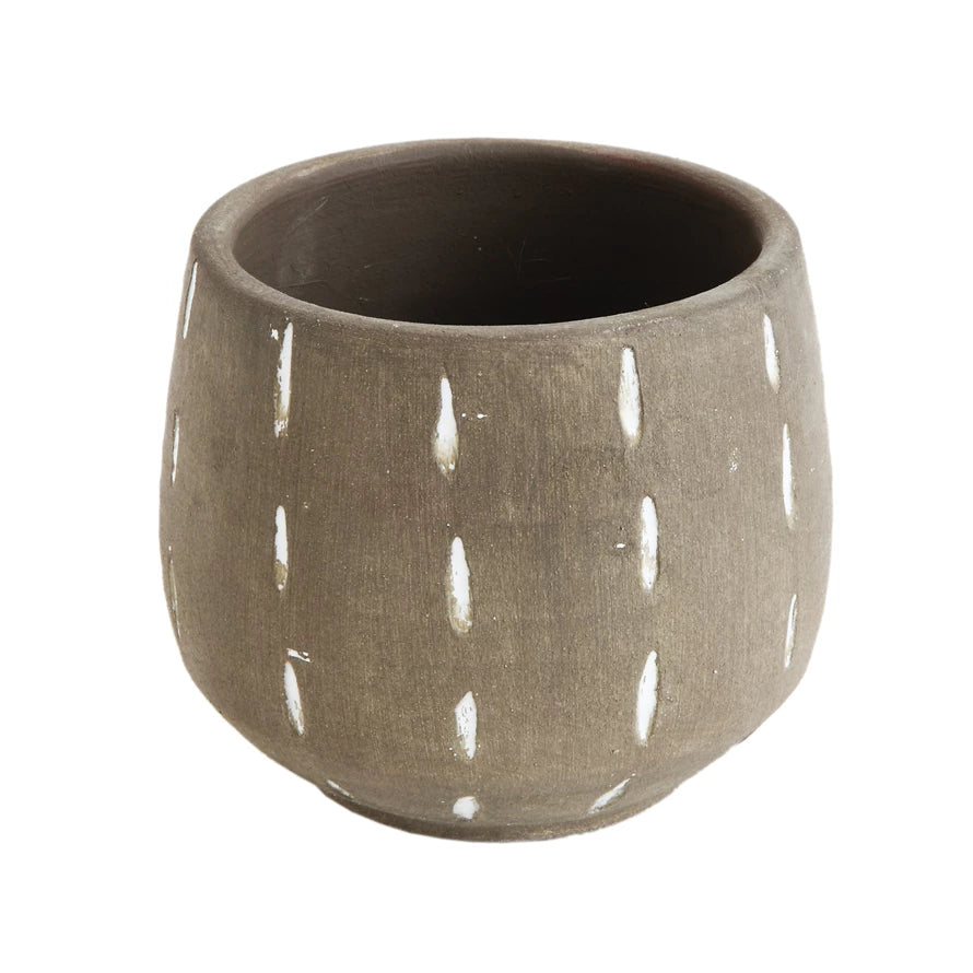 A grayish-brown terracotta planter with hand painted white lines.