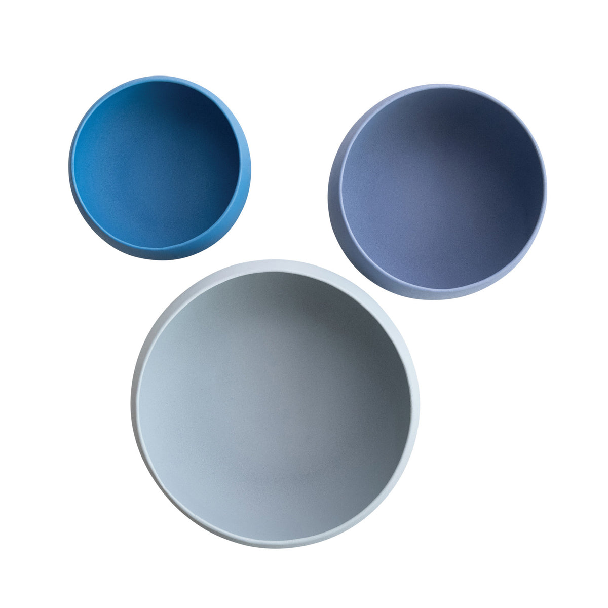 Three blue ceramic bowls of different sizes on a white background