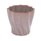 Decorative planter with wavy design on a white background