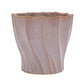Decorative planter with wavy design on a white background