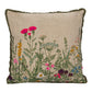 A square-shaped cotton slub pillow with a multicolor floral embroidery design, beads, and lace trim along the edges.