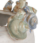 Stoneware planter with 3D snails on the rim and a reactive speckled glaze in blue, green, and cream finishes.