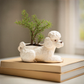 Hand-painted stoneware poodle planter with vintage reproduction design in white, brown, and black