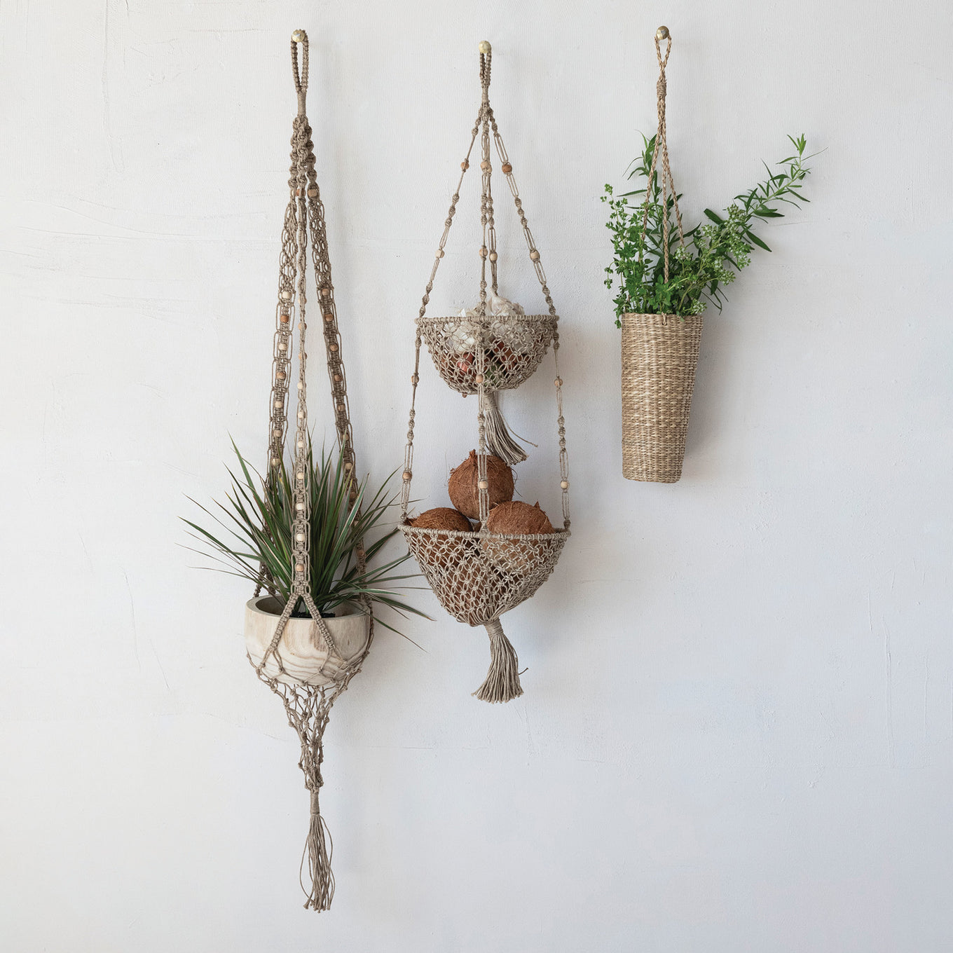 Three hanging planters on a white wall