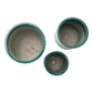 Three green ceramic pots of different sizes on a white background