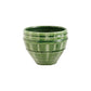 Green ceramic planter with textured design on a white background