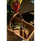 Wicker basket with floral arrangement and shears on a textured surface