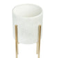 White woven basket with gold metal stand on a white background