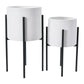 Two white textured planters with black stands on a white background