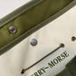 A green and beige Ferry-Morse garden tool bag with multiple pockets and a drawstring closure.