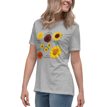 A woman smiling and wearing a grey crew neck t-shirt with a graphic of sunflowers in different colors on the front.