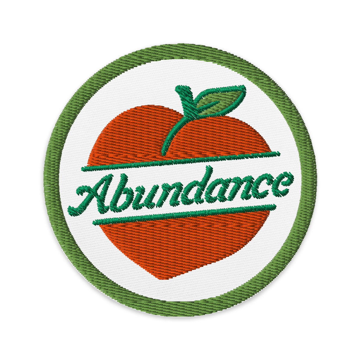Circular patch with an orange and green design featuring the word 'Abundance'.