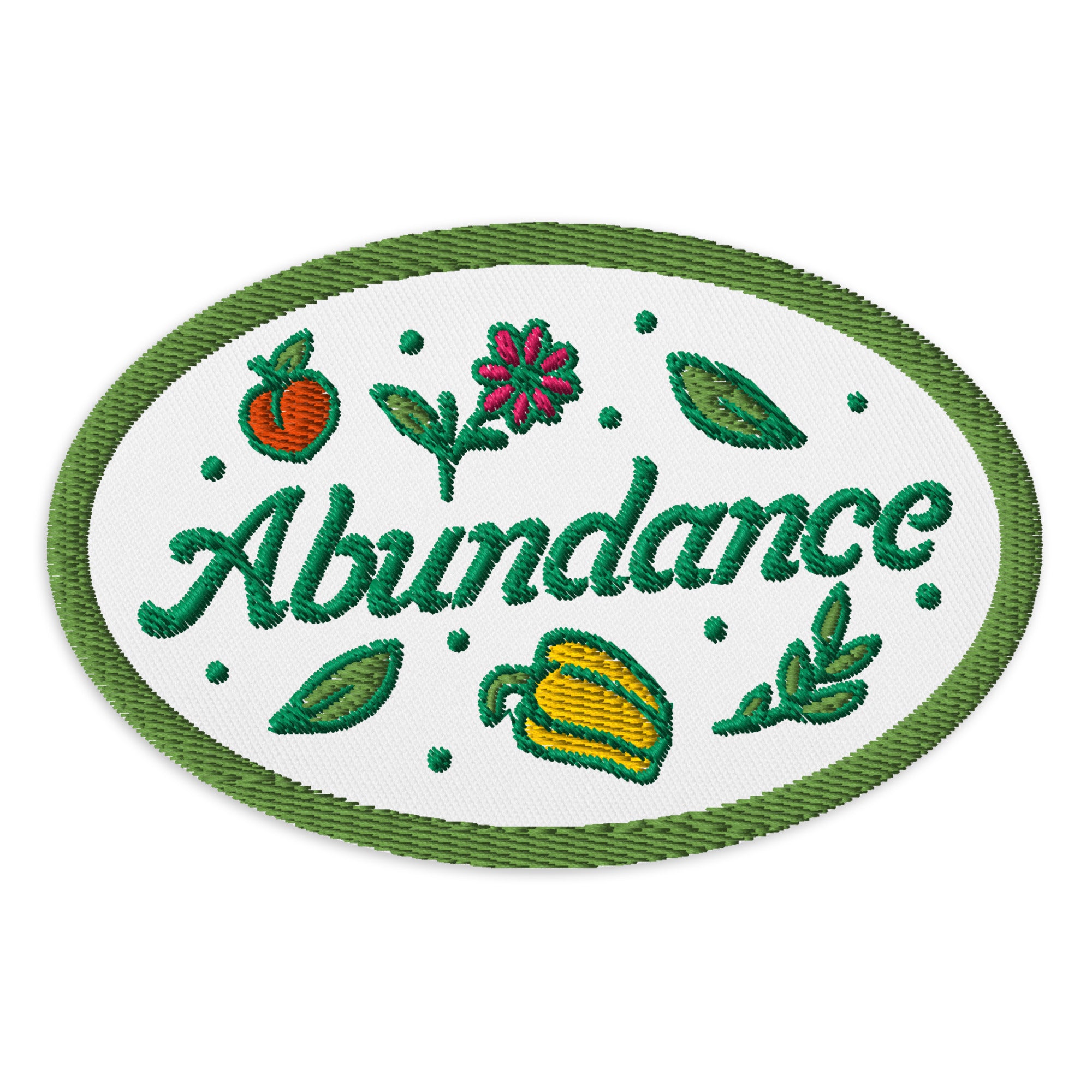 Embroidered patch with the word 'Abundance' and vegetables on a white background