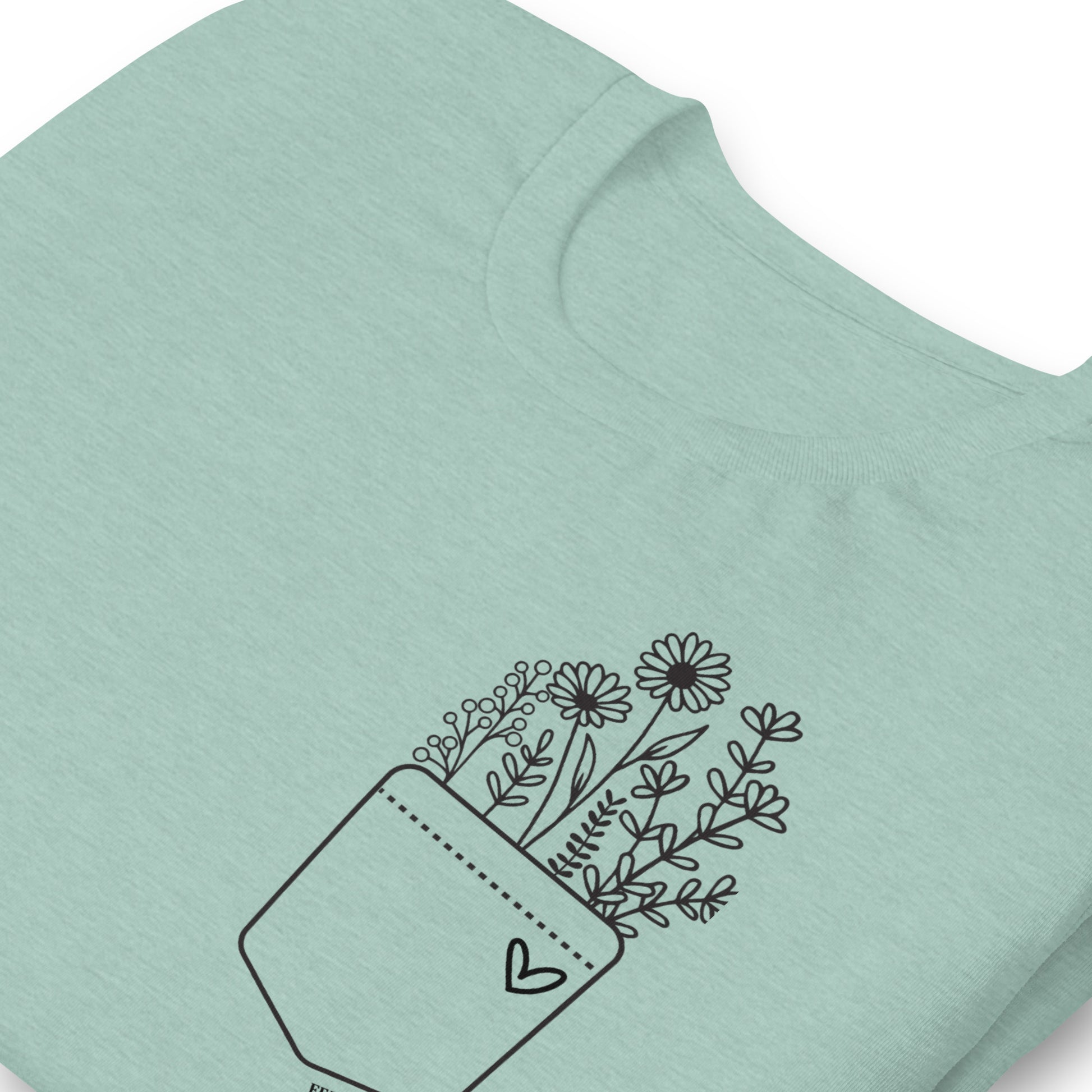 Light blue t-shirt with a black floral design on a white background