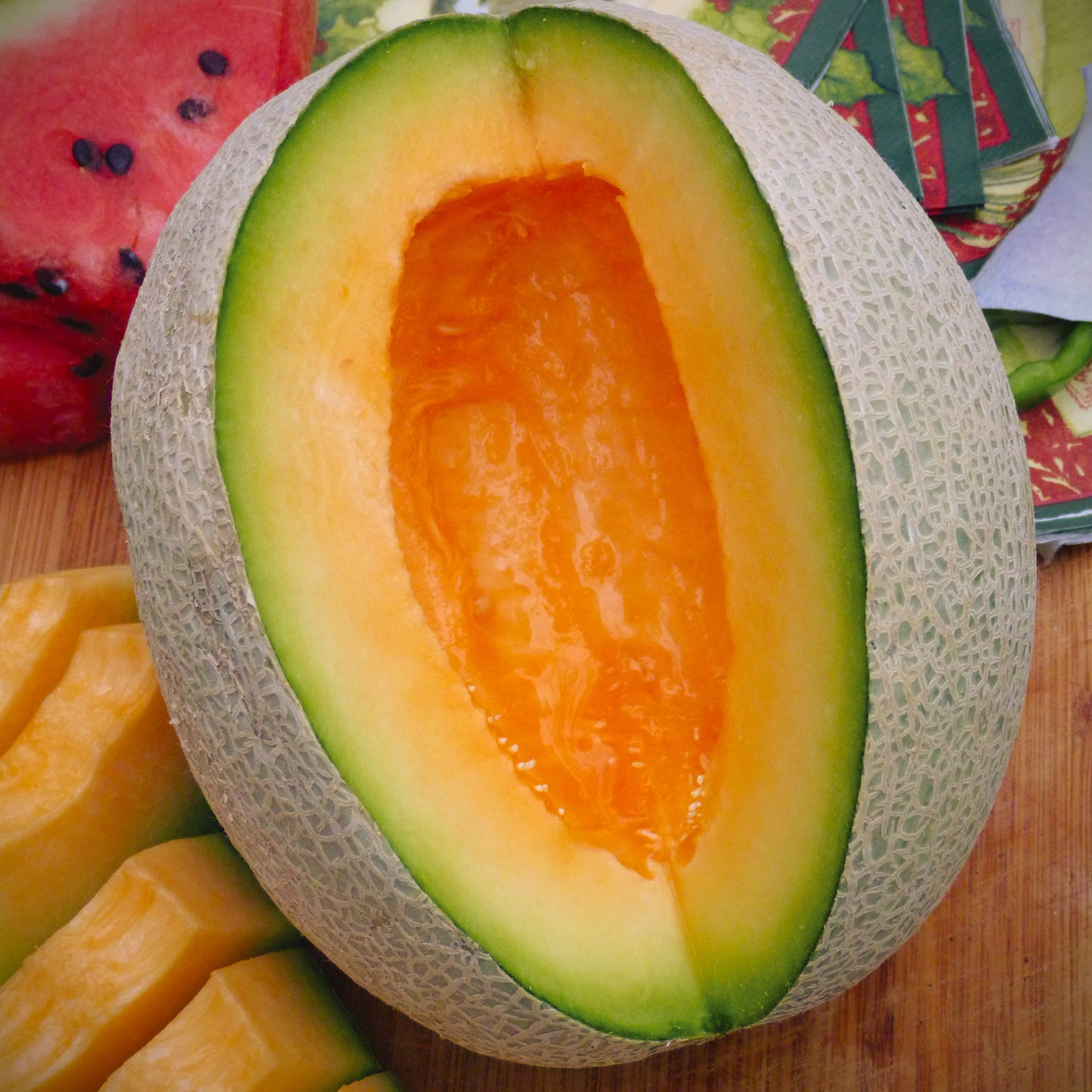 Sierra Gold Heirloom Cantaloupe seeds fully matured and recently pulled. A quarter of this melon is missing to display the inside of its juicy flesh.