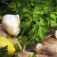 Aromatico a Costa Rossa Parsley seeds fully grown and matured, harvested and on a cutting block with some lemon and garlic.